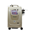 Oxymed Mini 10 LPM home oxygen concentrator with ergonomic handle, dual oxygen outlets, flow meter, and mobility wheels.