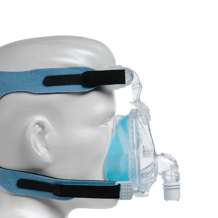 A side view of a mannequin wearing a Philips Respironics TrueBlue Full Face mask and headgear.