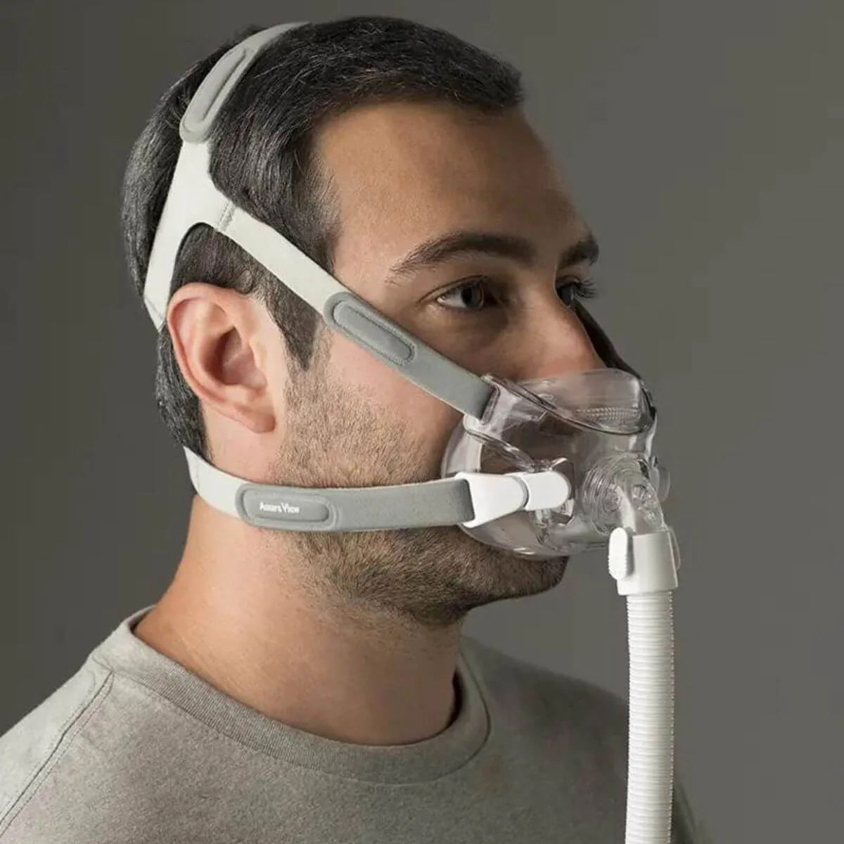 Side view of a man wearing the Philips Respironics Amara View Full Face Mask and the headgear for CPAP therapy.