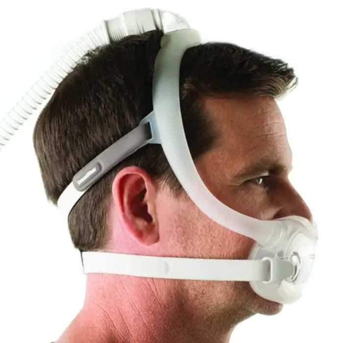 Side view of a man wearing a Philips Respironics DreamWear Full Face CPAP mask with headgear, designed for comfortable sleep apnea therapy and a secure fit.