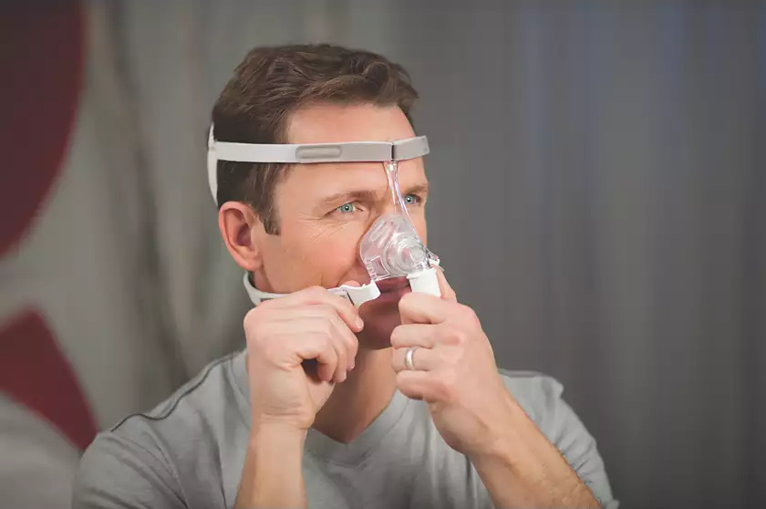 A man wearing the Philips Respironics Pico Nasal mask.